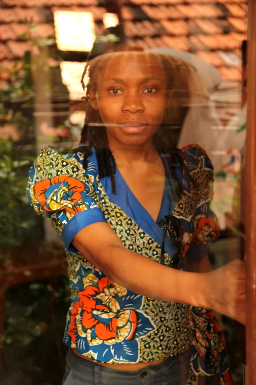 a girl holding a phone in a glass case