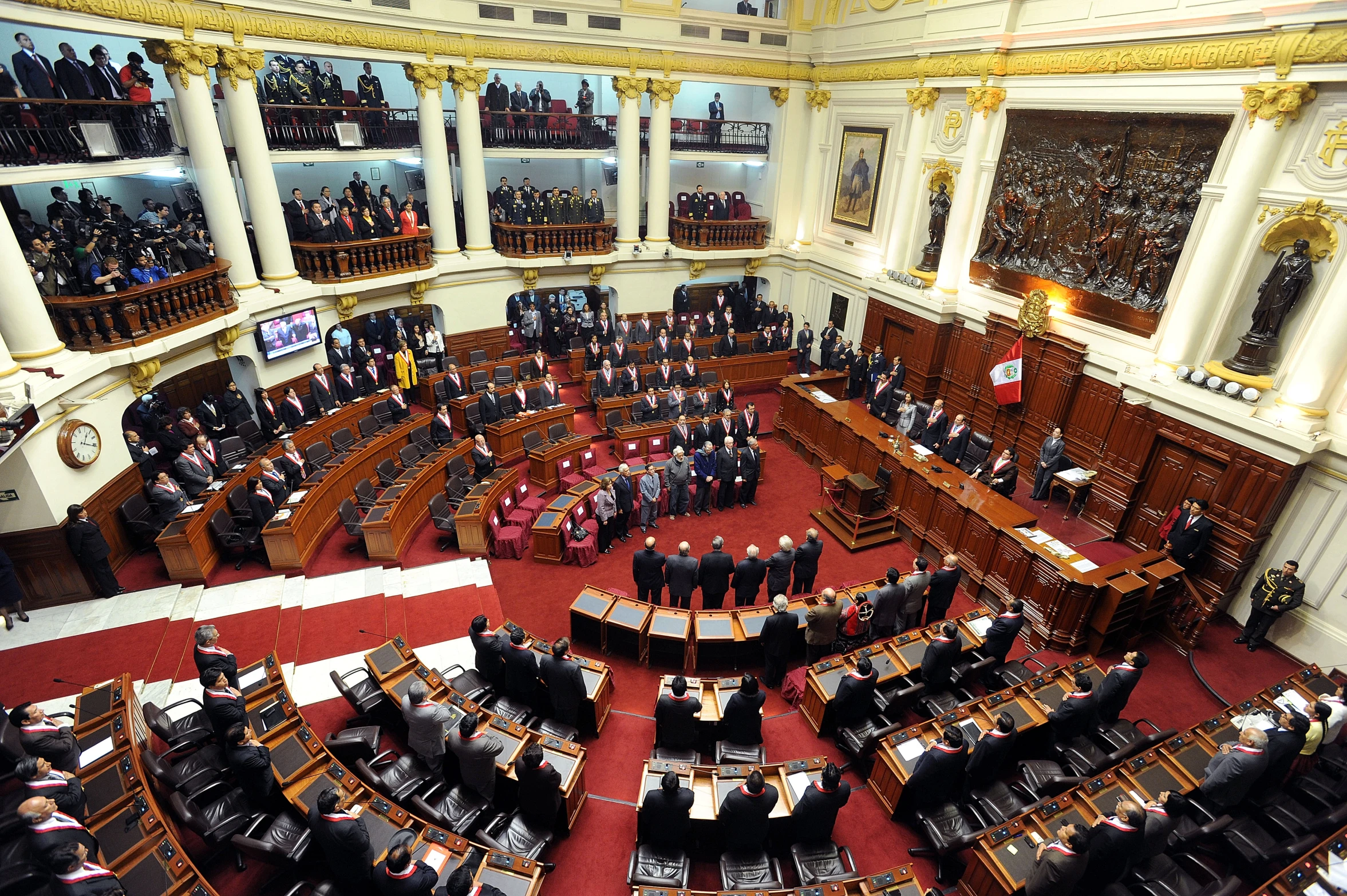 a large room with many wooden furniture and people inside