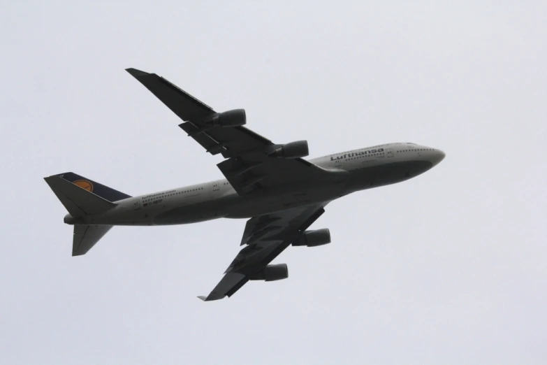 a large jetliner flying through a cloudy sky