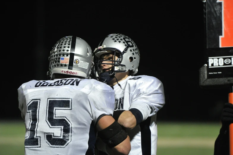 two football players emcing while standing on the field