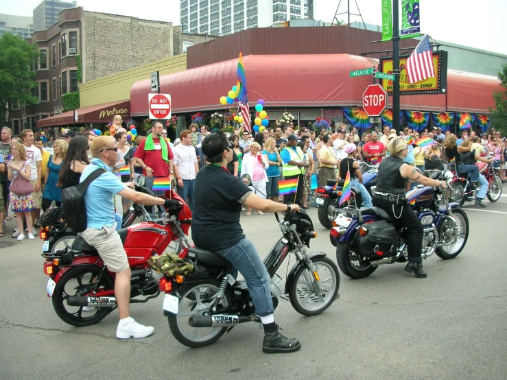a group of people on motorcycles with a crowd