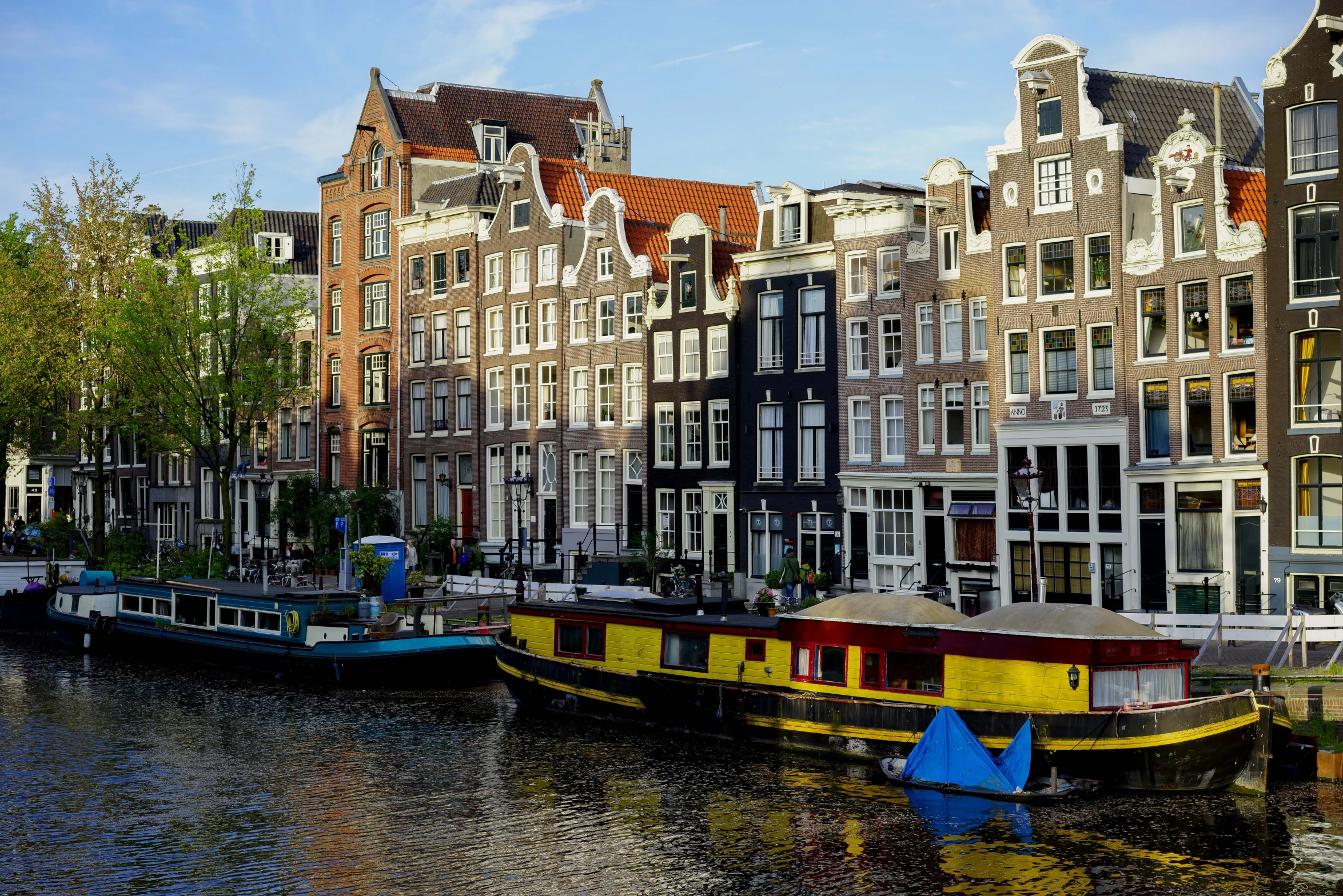 several boats docked next to the canals on a sunny day