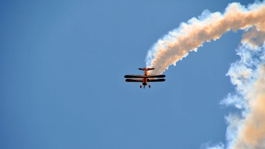 an airplane with smoke trailing behind it and a very big plume of smoke coming out the back