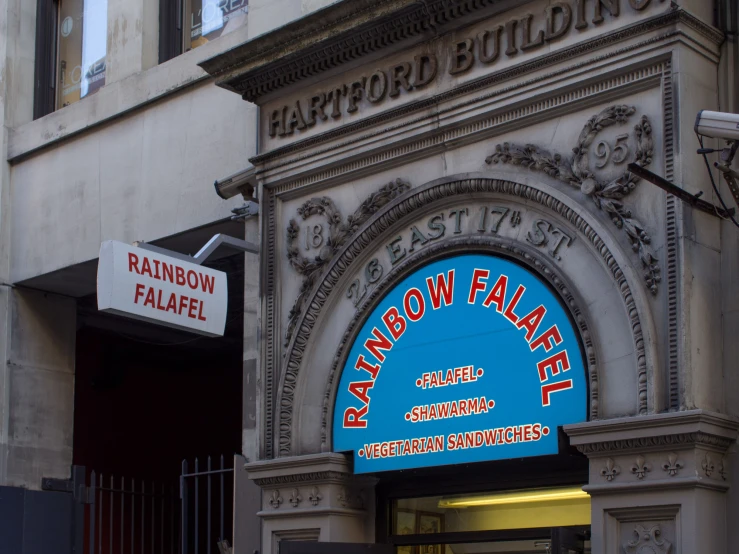 a building entrance with a sign reading rainbow palace