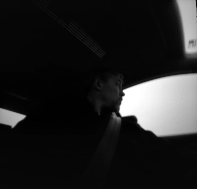 a man sitting in the back seat of a car