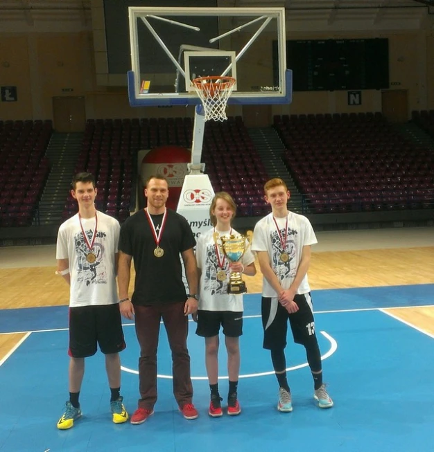 several people in white shirts on a blue and yellow court