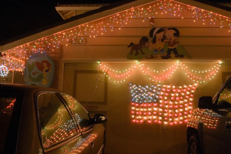 a christmas themed house covered in decorations and lights