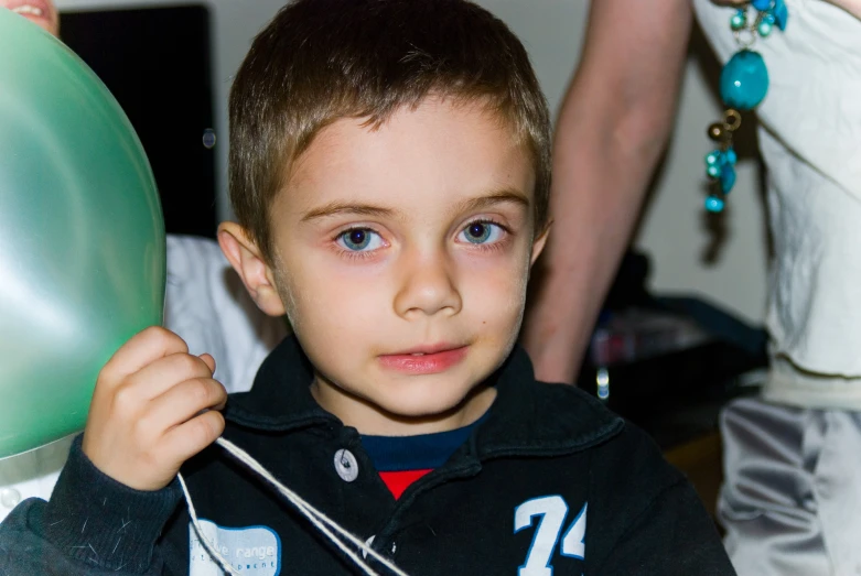 a boy who is holding onto the handle of a kite