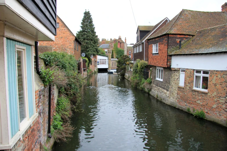 a body of water is flowing down a narrow street