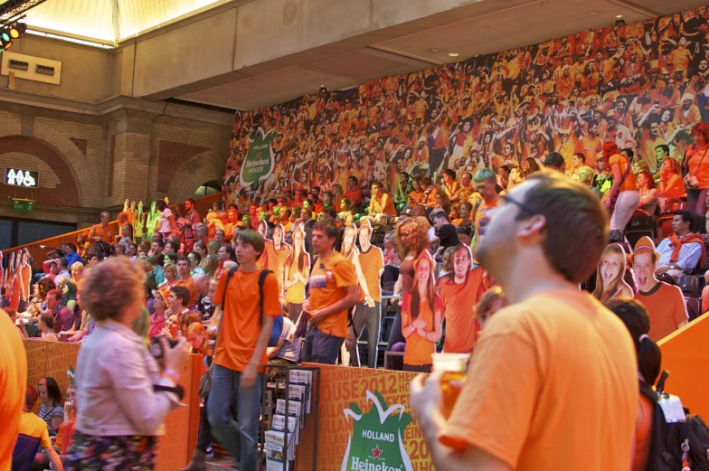 a large group of orange fans in a stadium