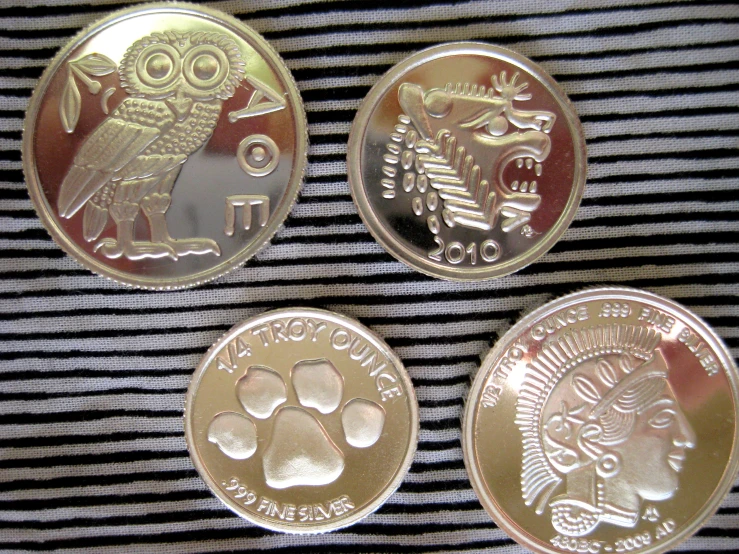 3 coins with various designs on them