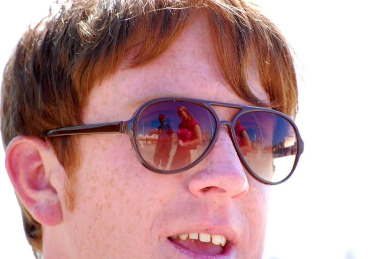 a close up of a man with sunglasses on