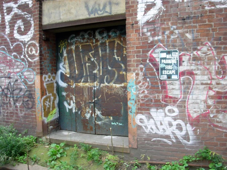 old door with various graffits painted on the outside