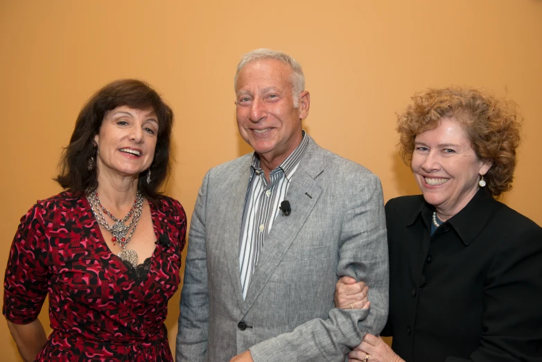 three people pose for the camera smiling