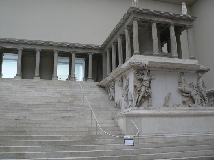 a statue is on a cement stair case