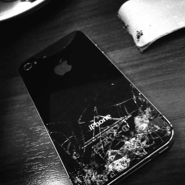 black and white pograph of an iphone smashed in two