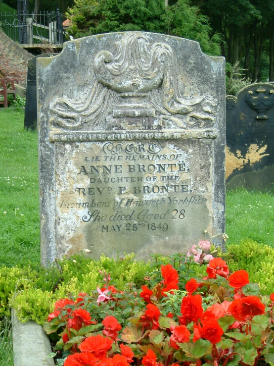 a grave with some flowers near by