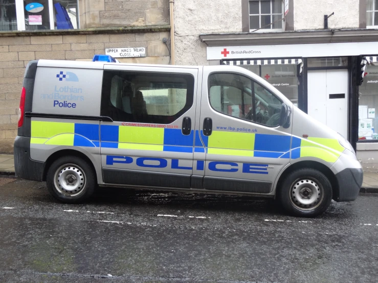 the police van is parked outside of a building