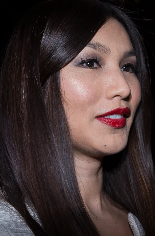 a young lady with long dark hair and red lipstick