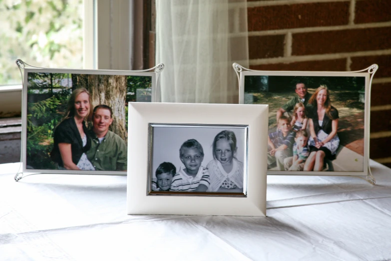 three po frames that have family pos taped in them