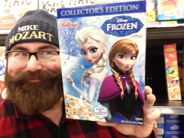 a man standing next to each other holding two disney frozen book's