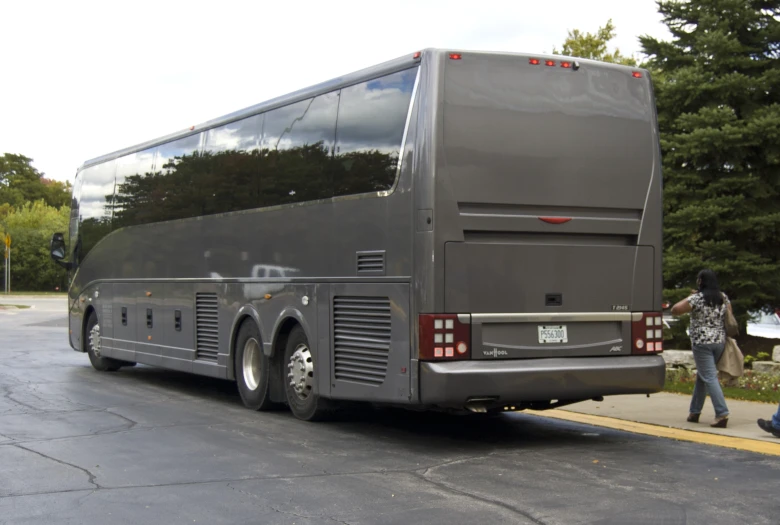 a black bus sitting on top of a street