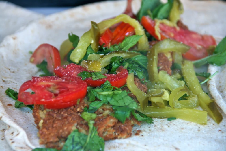 a plate topped with tortilla filled with vegetables