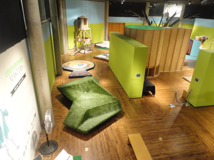 an area with chairs and green partitions in it