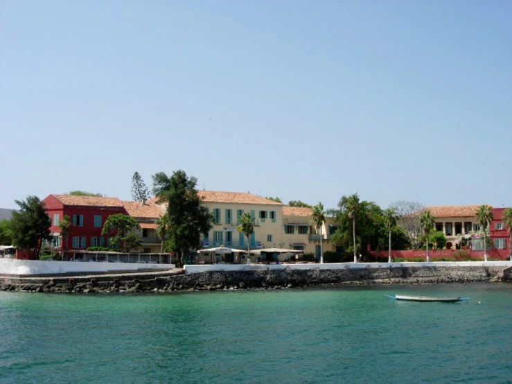 the ocean with houses and trees next to it