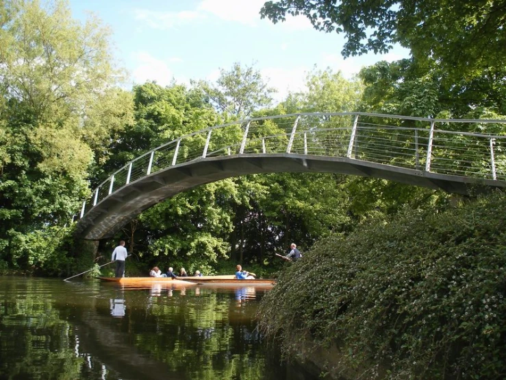 a boat travels under an old bridge on a lake