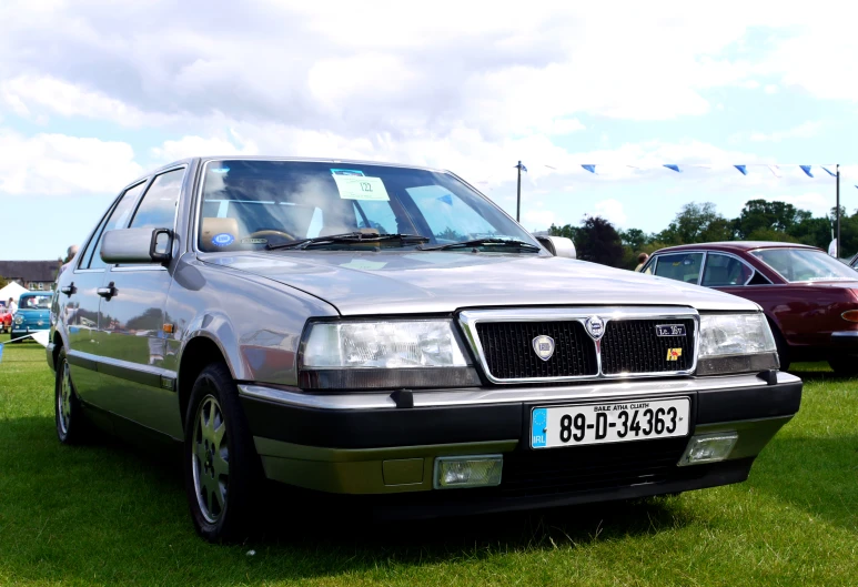 a car is on a field with other cars