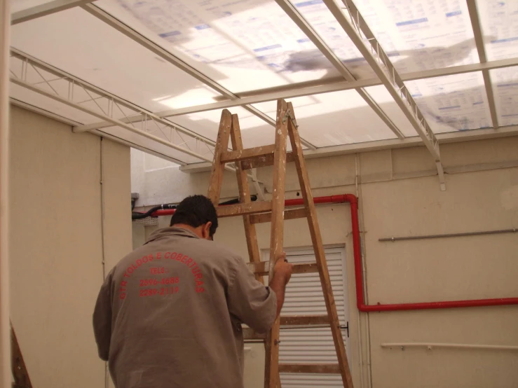 a man that is standing up on a ladder