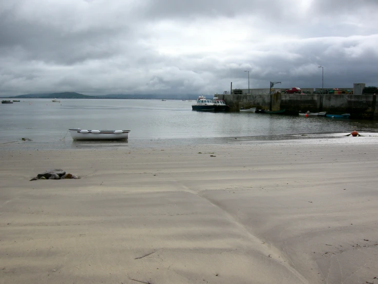 a small boat sitting on top of a beach