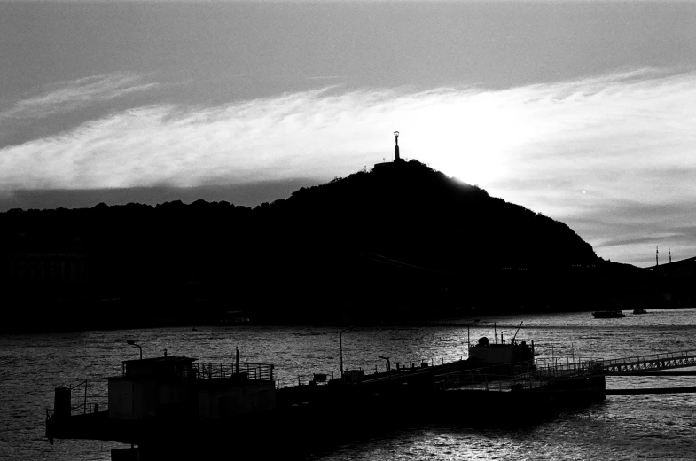 an old ferry sailing near a large mountain on a lake