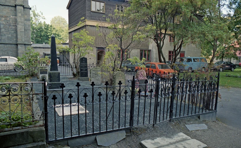 a home with a large wrought iron fence in the yard