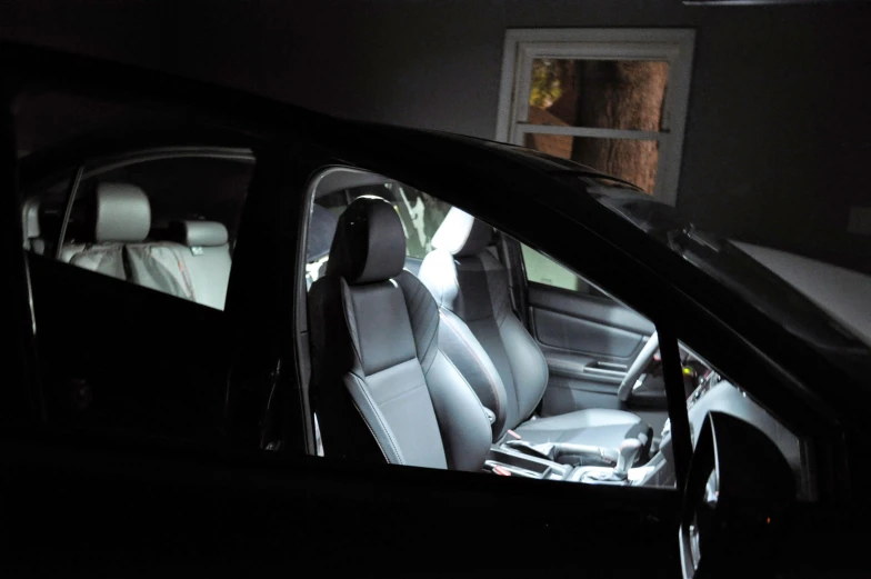 the interior of a car that is lit up in the dark