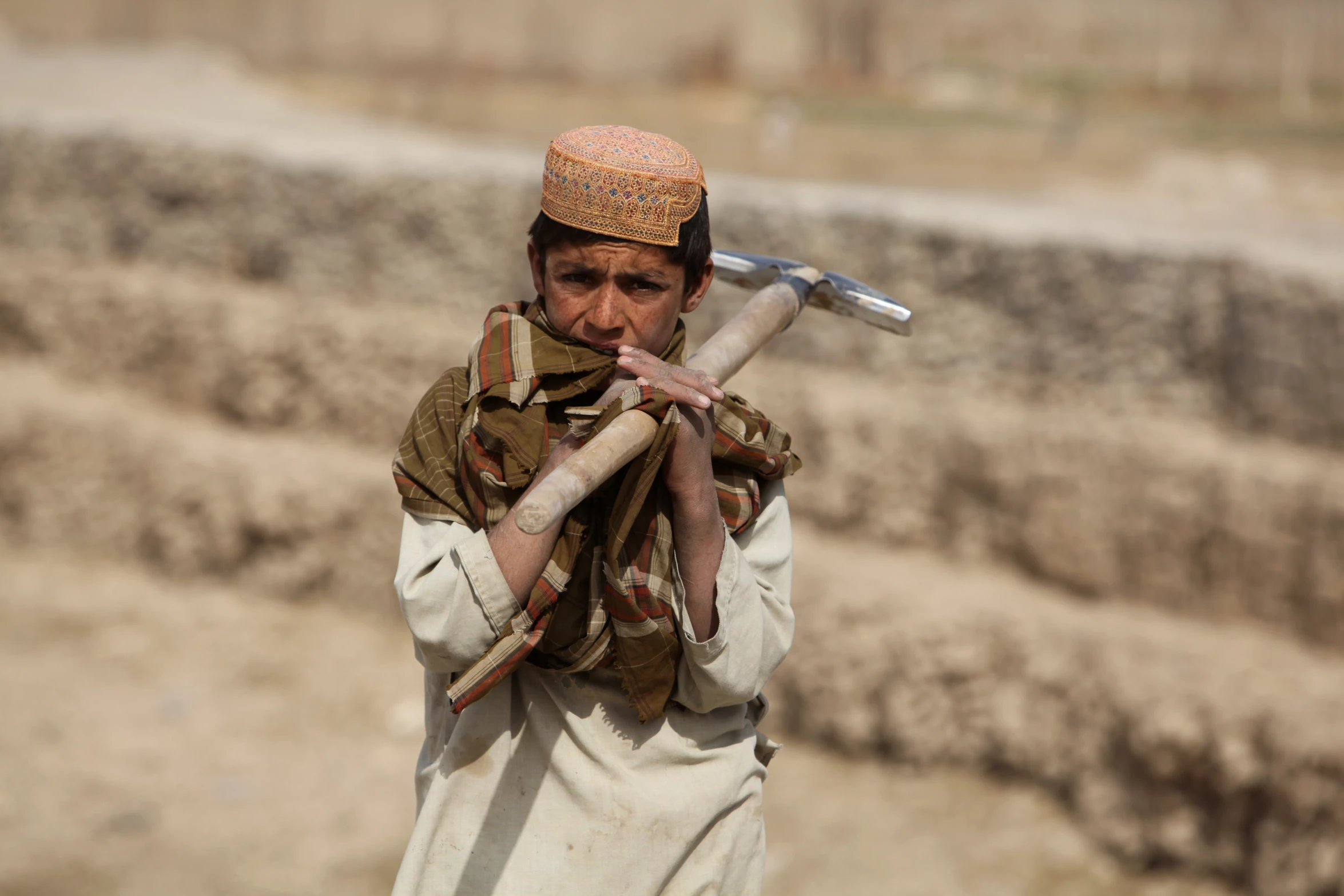 man wearing brown shirt carrying baseball bat and head cover