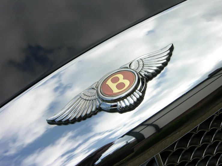 the front end of a bentley logo on the hood