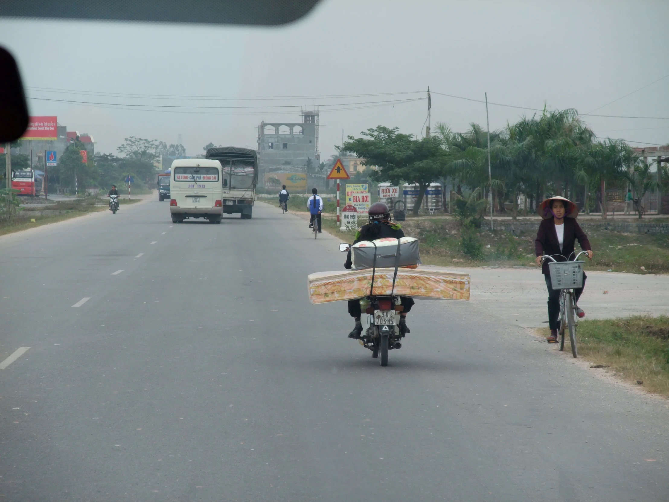 a person on a bike with a small surf board