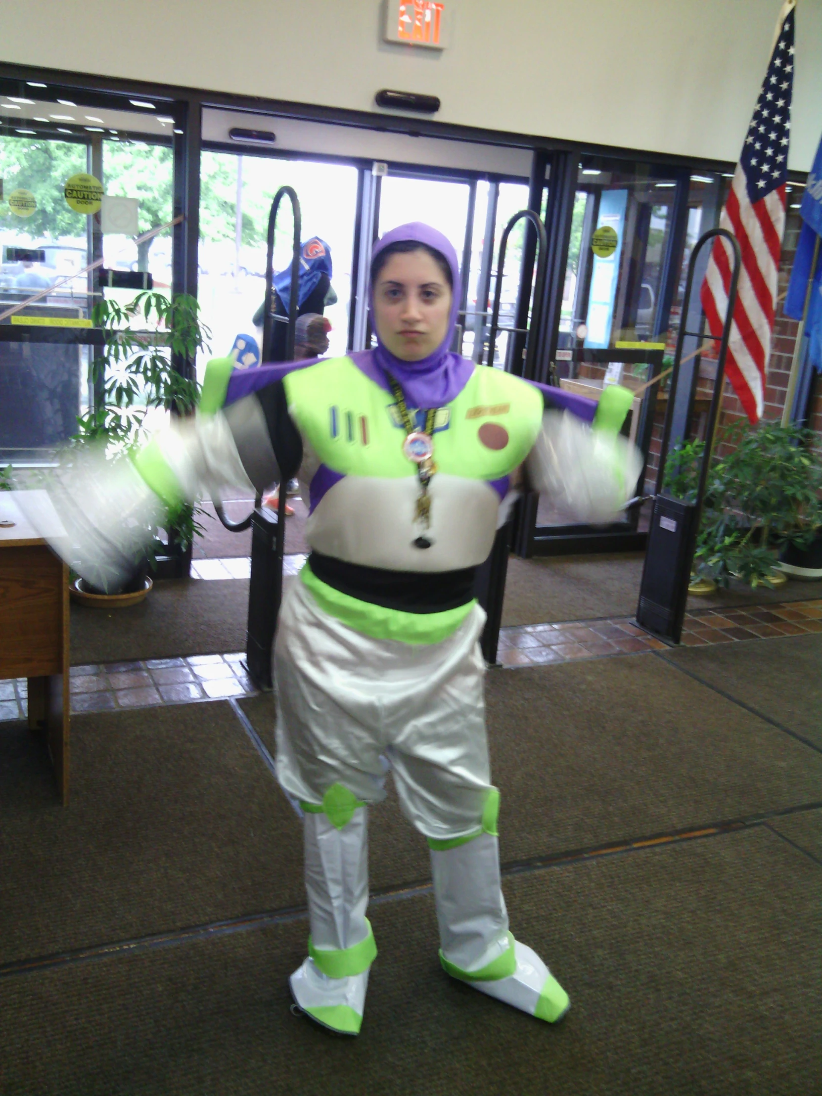 a girl in buzz lightyear costume holding some thing