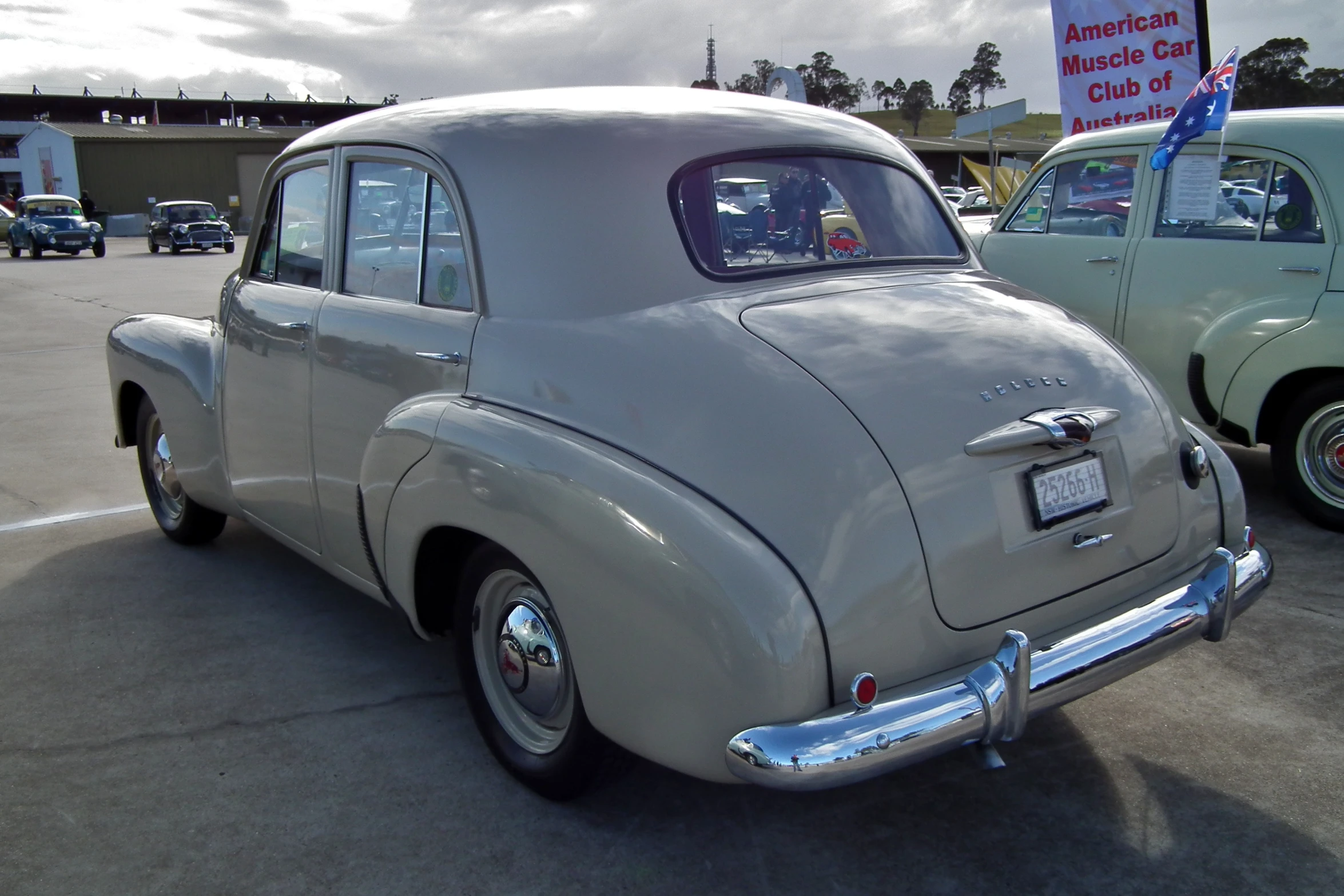 a gray car sitting in a parking lot