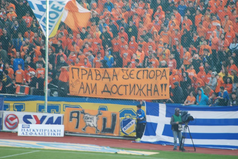 a pographer holding up a camera on top of a soccer field