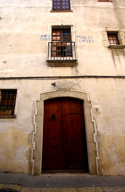 a large building with wooden doors in front