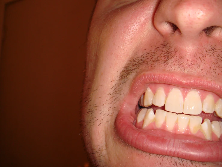 a close up view of a person with a white tooth