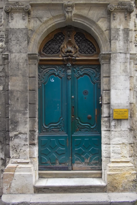 the large, intricate doorway is a blue door