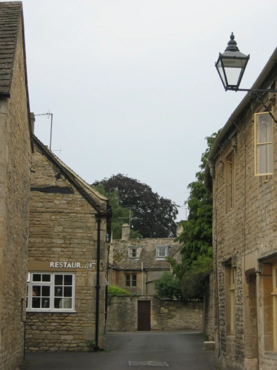 a small lamp hanging off the side of an old house