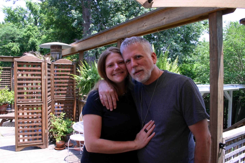 a woman hugging a man with his arm around her