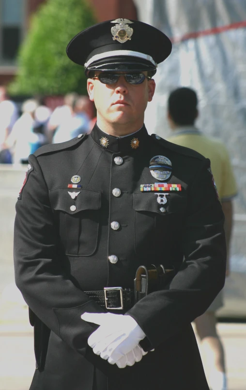 a man wearing uniform and white gloves holding his hand near the pocket