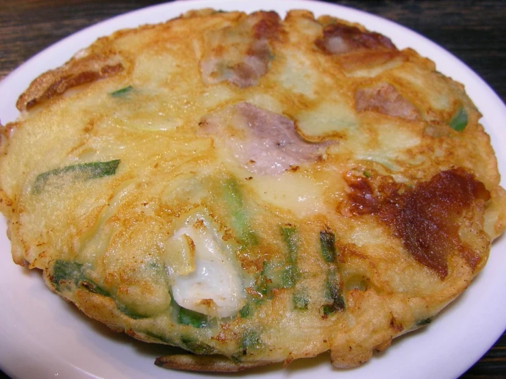 a plate filled with food covered in sauces and vegetables