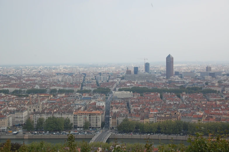 a large city has brown buildings and green trees